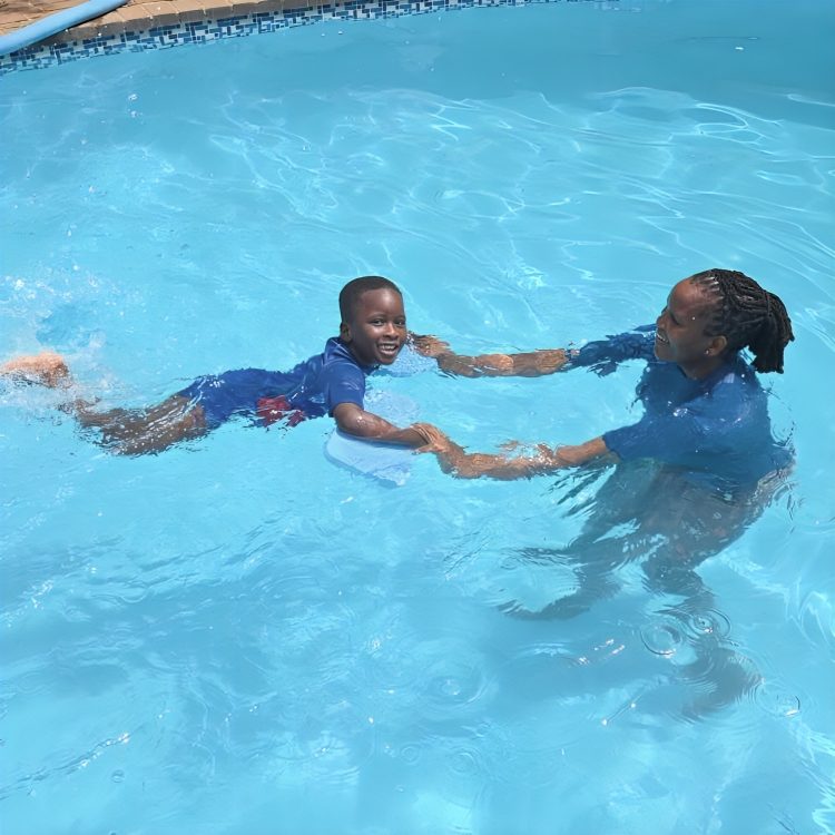A Toddies child having a one-on-one swimming lesson with a teacher